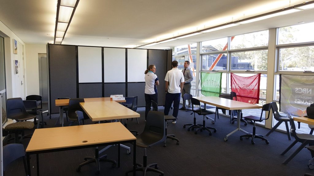 Mobile Whiteboard integrated into a folding classroom divider on wheels- portable partition